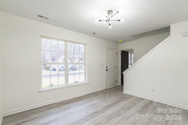 interior space with a chandelier and light wood-type flooring