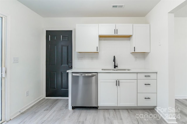 kitchen featuring dishwasher, backsplash, white cabinets, sink, and light hardwood / wood-style floors