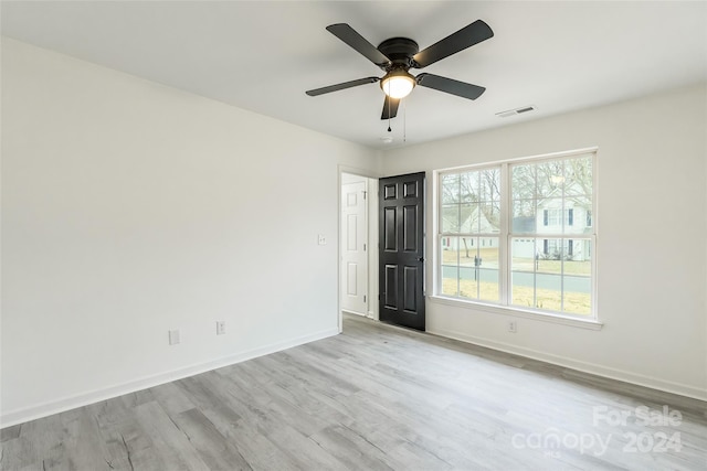 empty room featuring ceiling fan and light hardwood / wood-style flooring