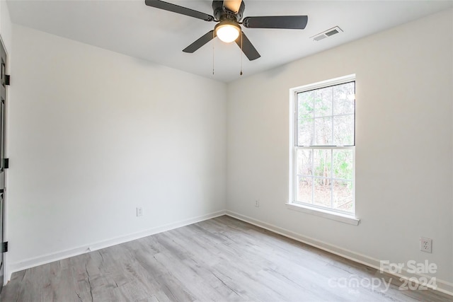 spare room with light wood-type flooring and ceiling fan