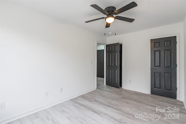 unfurnished bedroom featuring ceiling fan and light hardwood / wood-style flooring