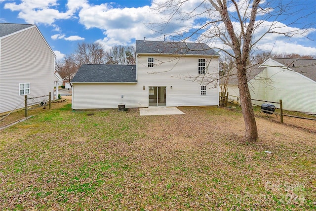 back of house with a lawn and a patio