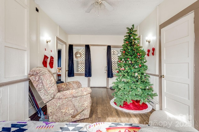 interior space with ceiling fan, hardwood / wood-style floors, and a textured ceiling