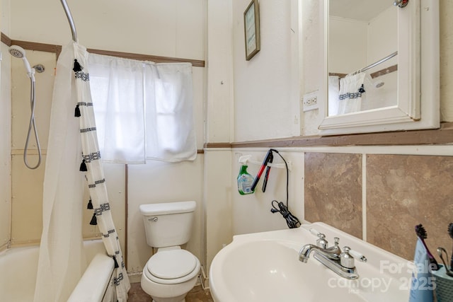 full bathroom featuring shower / bath combination with curtain, toilet, and sink