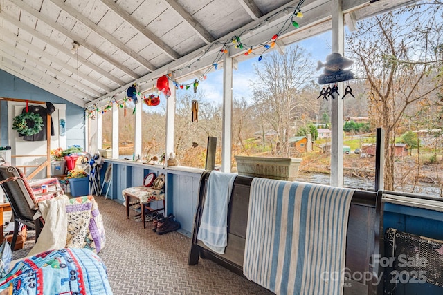 sunroom featuring vaulted ceiling with beams and wood ceiling