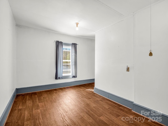 empty room with hardwood / wood-style flooring