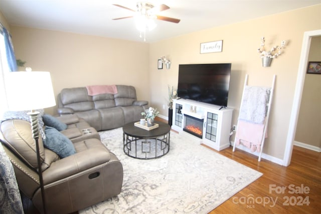 living room featuring ceiling fan and wood-type flooring