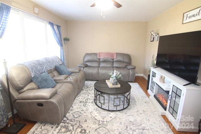 living room featuring hardwood / wood-style flooring and ceiling fan