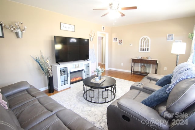 living room with ceiling fan and light wood-type flooring