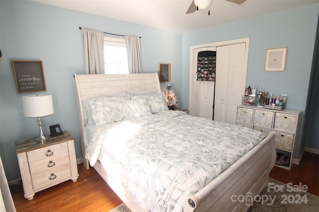 bedroom with ceiling fan, a closet, and dark wood-type flooring