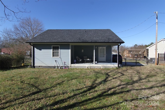 back of property with a porch and a yard