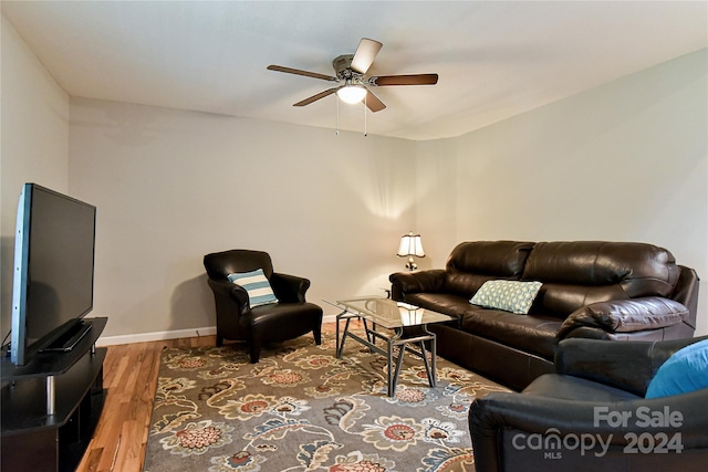 living room featuring ceiling fan and hardwood / wood-style floors