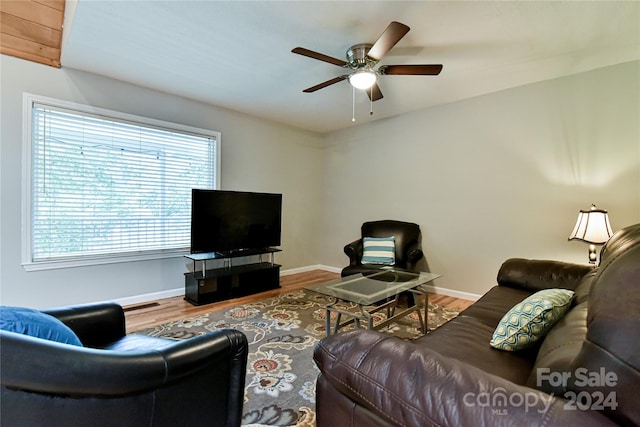 living room featuring ceiling fan, plenty of natural light, and wood-type flooring