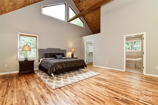 bedroom featuring ensuite bathroom, light hardwood / wood-style floors, wood ceiling, and high vaulted ceiling