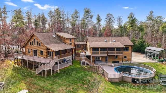 back of property with a wooden deck and a sunroom