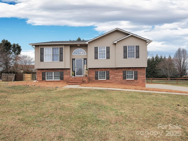 raised ranch featuring a front lawn