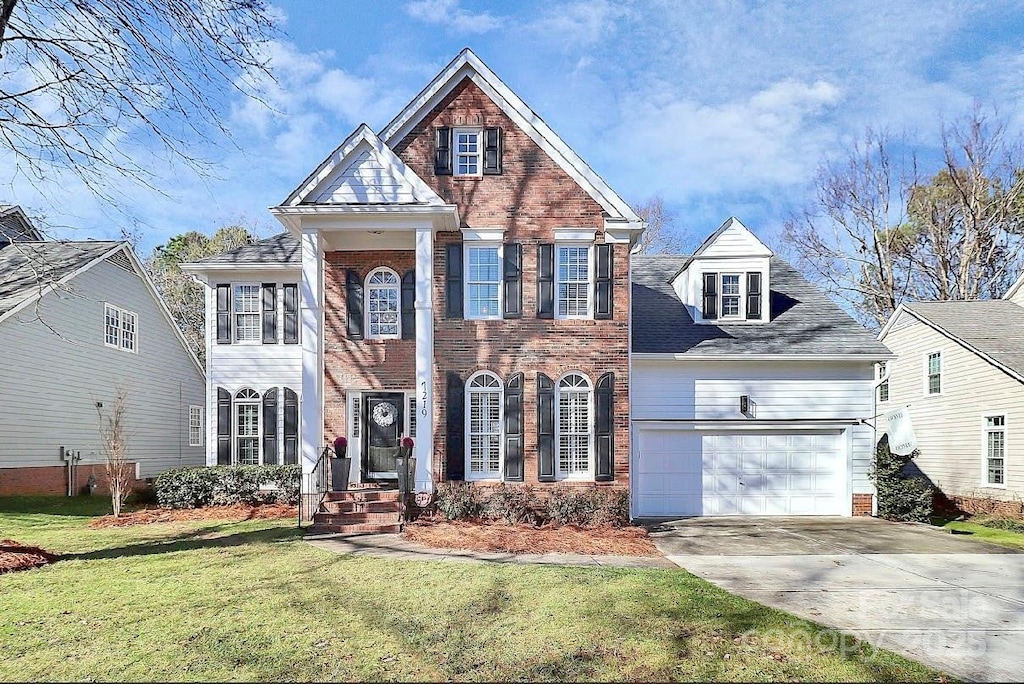 view of front of house featuring a garage and a front yard