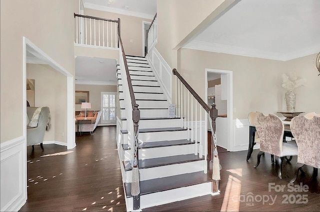 staircase featuring hardwood / wood-style floors and ornamental molding