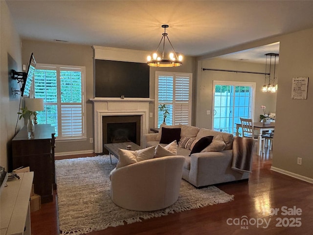 living room featuring dark wood-type flooring and a chandelier