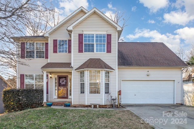 front facade with a front yard and a garage