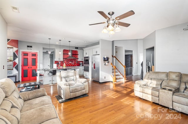 living room featuring light hardwood / wood-style flooring and ceiling fan