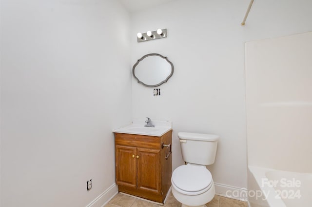 bathroom with tile patterned floors, vanity, toilet, and a bathing tub