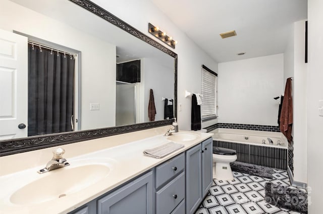 full bathroom with vanity, separate shower and tub, and toilet