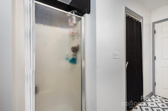 bathroom with a shower with door