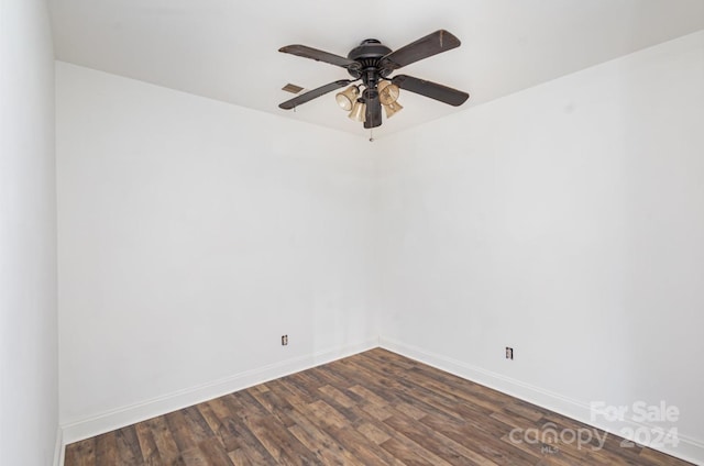 unfurnished room with ceiling fan and dark wood-type flooring