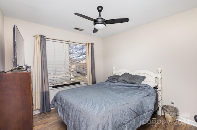 bedroom with ceiling fan and dark wood-type flooring