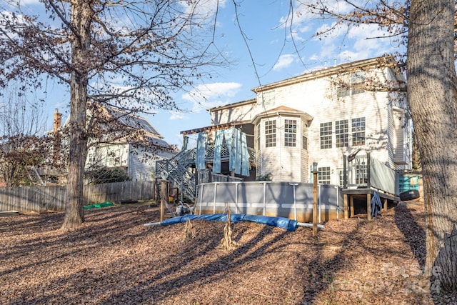 back of property with a swimming pool