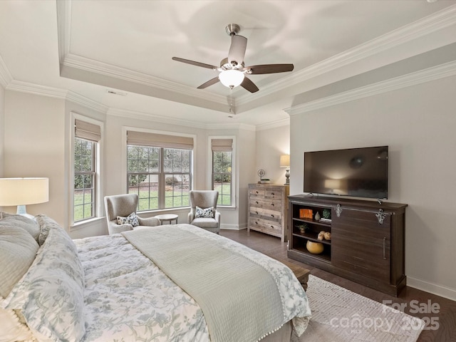 bedroom with a raised ceiling, dark hardwood / wood-style flooring, ceiling fan, and crown molding