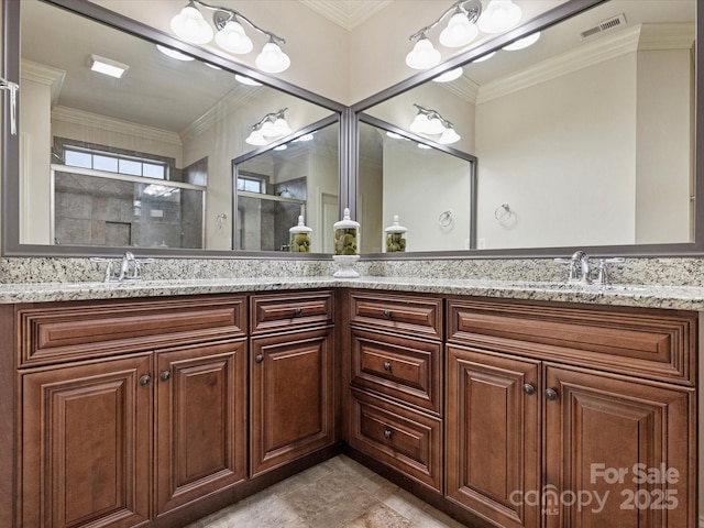 bathroom featuring vanity, a shower with door, and ornamental molding