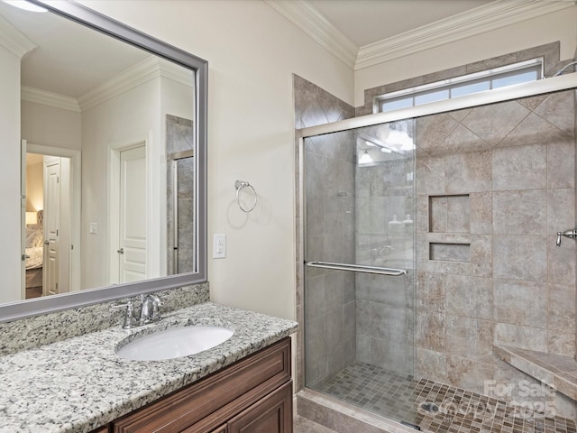 bathroom featuring crown molding, a shower with door, and vanity