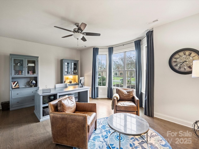 living area featuring ceiling fan and dark hardwood / wood-style floors