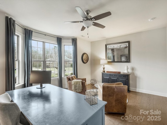 dining room with ceiling fan and dark wood-type flooring