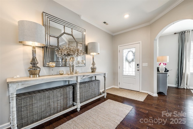 foyer entrance featuring crown molding and dark wood-type flooring