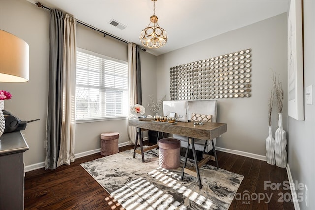 office space featuring a notable chandelier and dark hardwood / wood-style flooring