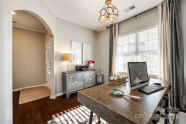 office area with a healthy amount of sunlight, ornamental molding, dark wood-type flooring, and an inviting chandelier