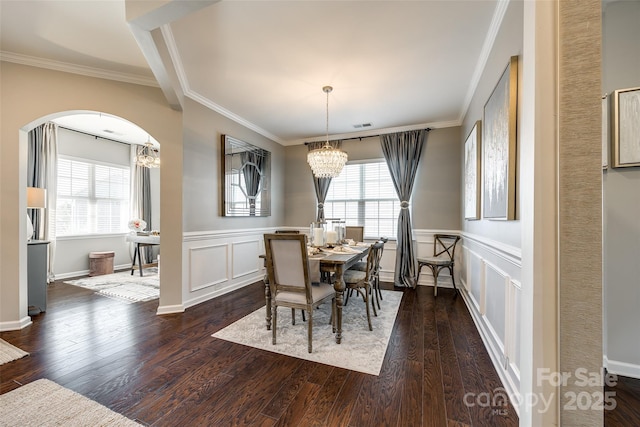 dining area featuring a chandelier, dark hardwood / wood-style floors, and ornamental molding