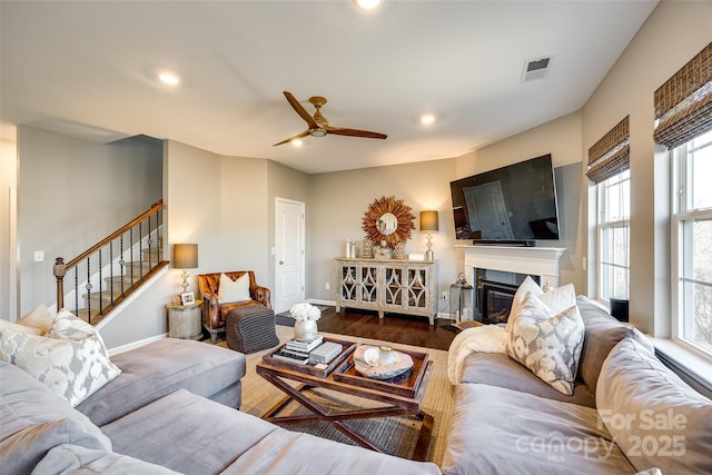 living room with hardwood / wood-style flooring and ceiling fan