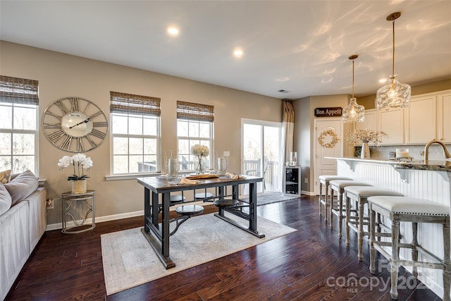 dining room featuring dark hardwood / wood-style flooring and sink