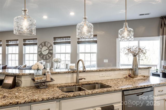 kitchen with dishwasher, sink, and decorative light fixtures