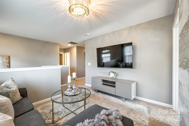 carpeted living room featuring a notable chandelier