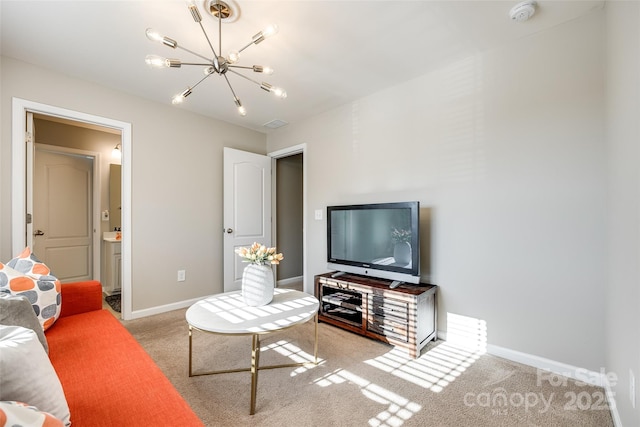 carpeted living room featuring an inviting chandelier