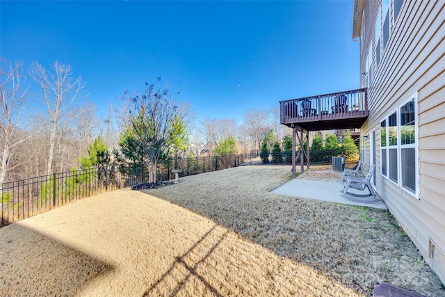 view of yard featuring a patio, a deck, and cooling unit