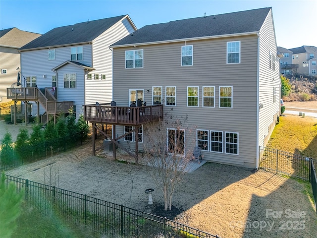 rear view of property featuring a wooden deck