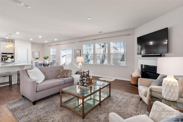 living room featuring hardwood / wood-style flooring, plenty of natural light, and a chandelier