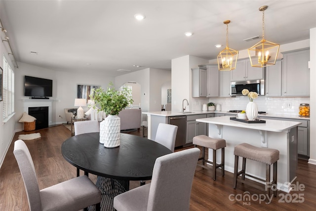 dining room with dark hardwood / wood-style floors and sink