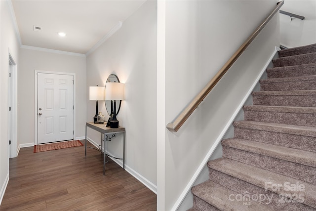 interior space featuring crown molding and dark wood-type flooring